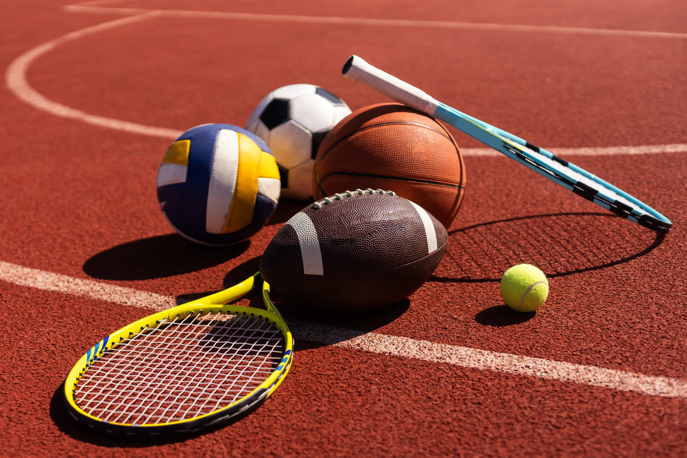 Sports balls and tennis rackets on a running track