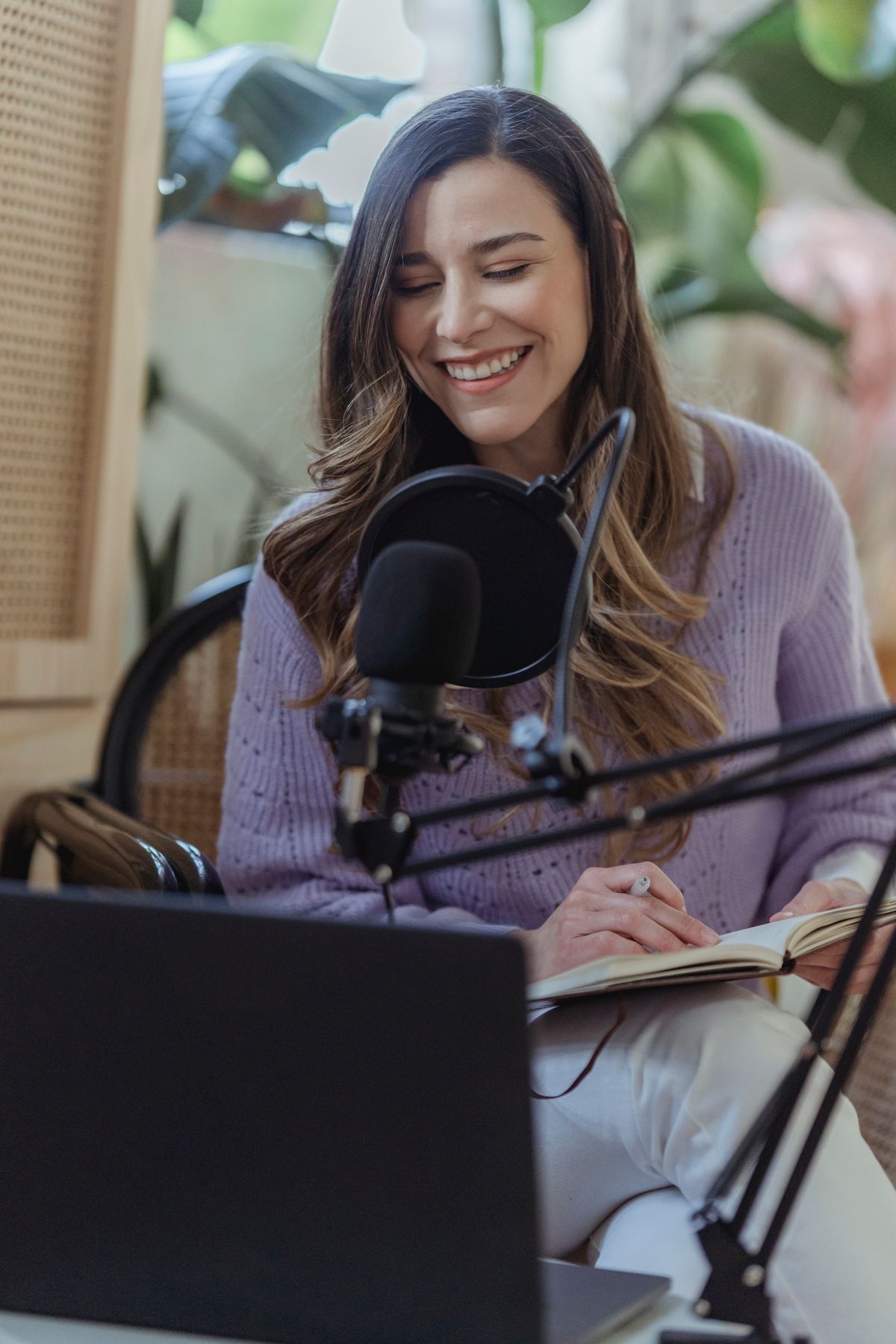 Creator speaking into a microphone while recording a podcast