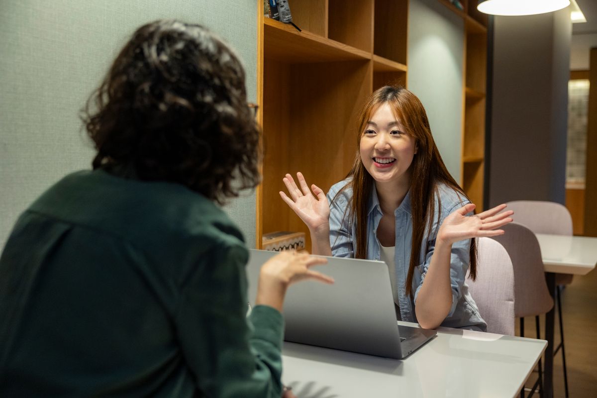 Entrepreneurs discussing work together at a laptop
